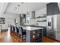 Modern kitchen with stainless steel appliances, granite countertops, and a stylish island with bar seating at 553 S Sherman St, Denver, CO 80209