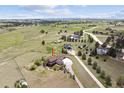 An aerial view showcases a sprawling residential property with mature trees and a long driveway at 2146 Savage Rd, Elizabeth, CO 80107