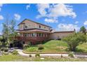 Exterior showcasing a multi-level deck and landscaping, enhanced by solar panels at 2146 Savage Rd, Elizabeth, CO 80107