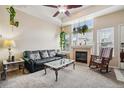 Inviting living room featuring a fireplace, ceiling fan, and stylish furniture at 8199 Welby Rd # 1903, Denver, CO 80229