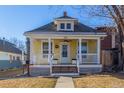 Charming yellow home featuring a covered front porch, white columns and a well-maintained front yard at 219 Terry St, Longmont, CO 80501