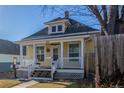 Quaint yellow home with white trim, covered porch, and well-kept lawn offers charm and curb appeal at 219 Terry St, Longmont, CO 80501