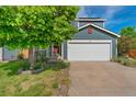 Charming home featuring a well-maintained yard, attached garage and light blue siding at 1086 Mockingbird St, Brighton, CO 80601