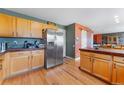 Spacious kitchen featuring stainless appliances, wood floors and wood cabinets at 1086 Mockingbird St, Brighton, CO 80601