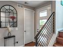 Bright entryway features modern staircase, stylish mirror and decor, creating an inviting first impression at 3698 Penang Dr, Castle Rock, CO 80109