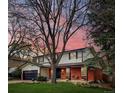 Charming two-story home with a brick facade and a well-manicured front yard at 8736 E Easter Ave, Centennial, CO 80112