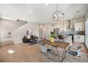 Bright dining area with wooden table and modern light fixture at 5018 S Prince Pl, Littleton, CO 80123