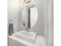 Modern powder room with an oval mirror and a floating vanity at 5018 S Prince Pl, Littleton, CO 80123