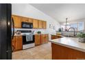 Bright kitchen with ample cabinet space, modern appliances, and a functional layout, perfect for cooking at 22815 E Progress Ave, Aurora, CO 80015