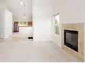 Inviting living room featuring a fireplace and an open floor plan leading to the kitchen at 15555 E 40Th Ave # 36, Denver, CO 80239