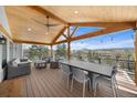 Spacious covered patio with a ceiling fan, string lights and stunning views at 3303 Wolfensberger Rd, Sedalia, CO 80135