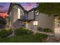 Beautiful home exterior featuring stone accents, lush landscaping, and a serene twilight sky at 13025 Grant E Cir # A, Thornton, CO 80241