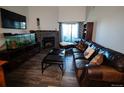 Living room with leather sofas, a fireplace, and a large TV at 11105 E Alameda Ave # 202, Aurora, CO 80012