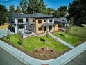 Aerial view of modern home with spacious yard, outdoor seating, and concrete patio at 2900 S Adams St, Denver, CO 80210