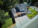 Aerial view of modern two-story home featuring a large driveway and attached two-car garage at 2900 S Adams St, Denver, CO 80210