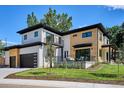 Exterior showcasing a modern home with wood accents, a balcony, and outdoor seating area at 2900 S Adams St, Denver, CO 80210