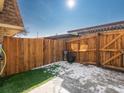 Fenced back yard with a combination of artificial turf and concrete, surrounded by a wood fence at 12993 W 20Th Ave, Golden, CO 80401