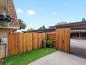 Private outdoor area features a wood fence, turf, and access to covered parking at 12993 W 20Th Ave, Golden, CO 80401