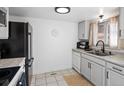 The kitchen is equipped with stainless steel appliances, white cabinets, and plenty of counter space at 12993 W 20Th Ave, Golden, CO 80401