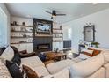 Inviting living room with cozy fireplace, built-in shelves, and comfortable sectional sofa at 21038 E Quincy Pl, Aurora, CO 80015