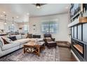 Bright living room featuring large windows, stylish decor, and a comfortable seating area at 21038 E Quincy Pl, Aurora, CO 80015