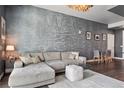 Comfortable living room features a plush sectional sofa, glass coffee table, and modern accent wall at 2001 Lincoln St # 920, Denver, CO 80202