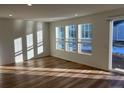 Bright and spacious living room with hardwood floors and sliding glass door at 1546 Farmstead St, Brighton, CO 80601