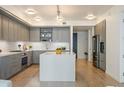 Stylish kitchen boasts gray cabinets, white countertops, and a stainless steel refrigerator and oven at 1750 Wewatta St # 809, Denver, CO 80202