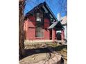 Charming red brick home featuring a covered porch and unique architectural details at 1449 N Downing St, Denver, CO 80218