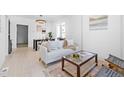 Bright living room featuring a couch, stylish coffee table, and modern decor at 2207 E 25Th, Denver, CO 80205