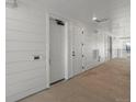 Hallway exterior with individual unit doors and exterior siding at 6153 N Ceylon St # 307, Denver, CO 80249