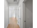 Bright hallway leading into a modern home with light hardwood floors at 6153 N Ceylon St # 307, Denver, CO 80249