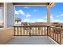 Cozy back porch area with wood railing, offering peaceful views of the neighborhood at 10723 N Montane Dr, Broomfield, CO 80021