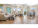 Bright living room featuring hardwood floors, a dining space and comfortable seating area at 10723 N Montane Dr, Broomfield, CO 80021
