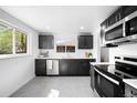 Modern kitchen with stainless steel appliances and sleek, dark cabinetry at 1148 N Clinton St, Aurora, CO 80010