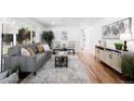 Bright living room featuring hardwood floors and stylish neutral decor at 1148 N Clinton St, Aurora, CO 80010