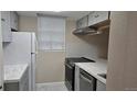 Kitchen featuring modern appliances and marble countertops at 12450 E Cornell Ave # 101, Aurora, CO 80014