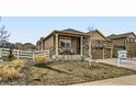 Inviting front yard with a cozy porch and seating area, showcasing the home's curb appeal at 6045 High Timber Cir, Castle Rock, CO 80104