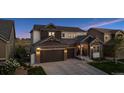 Beautiful two-story home with a two-car garage and lush green lawn at 3056 Yale Dr, Broomfield, CO 80023