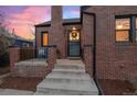 Brick steps leading to a charming front door with a wreath at 3633 N Cook St, Denver, CO 80205