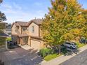 Charming two-story home with an attached garage and a mature shade tree in the front yard at 6135 S Paris St, Englewood, CO 80111