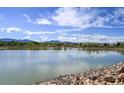Scenic lake view with blue skies and distant mountains at 9740 W 104Th Dr, Westminster, CO 80021