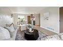 Bright living room showcasing neutral colors, natural light, and a modern open layout to the dining area at 9740 W 104Th Dr, Westminster, CO 80021