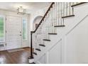 Classic staircase with white railings and dark wood steps at 5022 E 17Th Ave, Denver, CO 80220