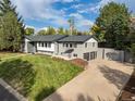 Stunning two-story home with a well-manicured lawn and an attached two-car garage at 6088 S Lakeview St, Littleton, CO 80120