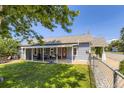 Charming home featuring a covered porch with outdoor seating and a spacious, well-maintained backyard at 235 W Lehigh Ave, Englewood, CO 80110
