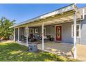 Charming covered porch with a welcoming red door and comfortable seating area at 235 W Lehigh Ave, Englewood, CO 80110