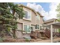 Charming home with a brick and wood facade, complemented by lush landscaping at 1885 S Quebec Way # M101, Denver, CO 80231