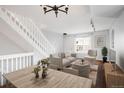 Open-concept living area with staircase, hardwood floors, and stylish decor for a modern feel at 1885 S Quebec Way # M101, Denver, CO 80231