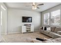 Cozy living room with neutral carpet, TV on wall, and modern decor at 6491 N Danube St, Denver, CO 80249